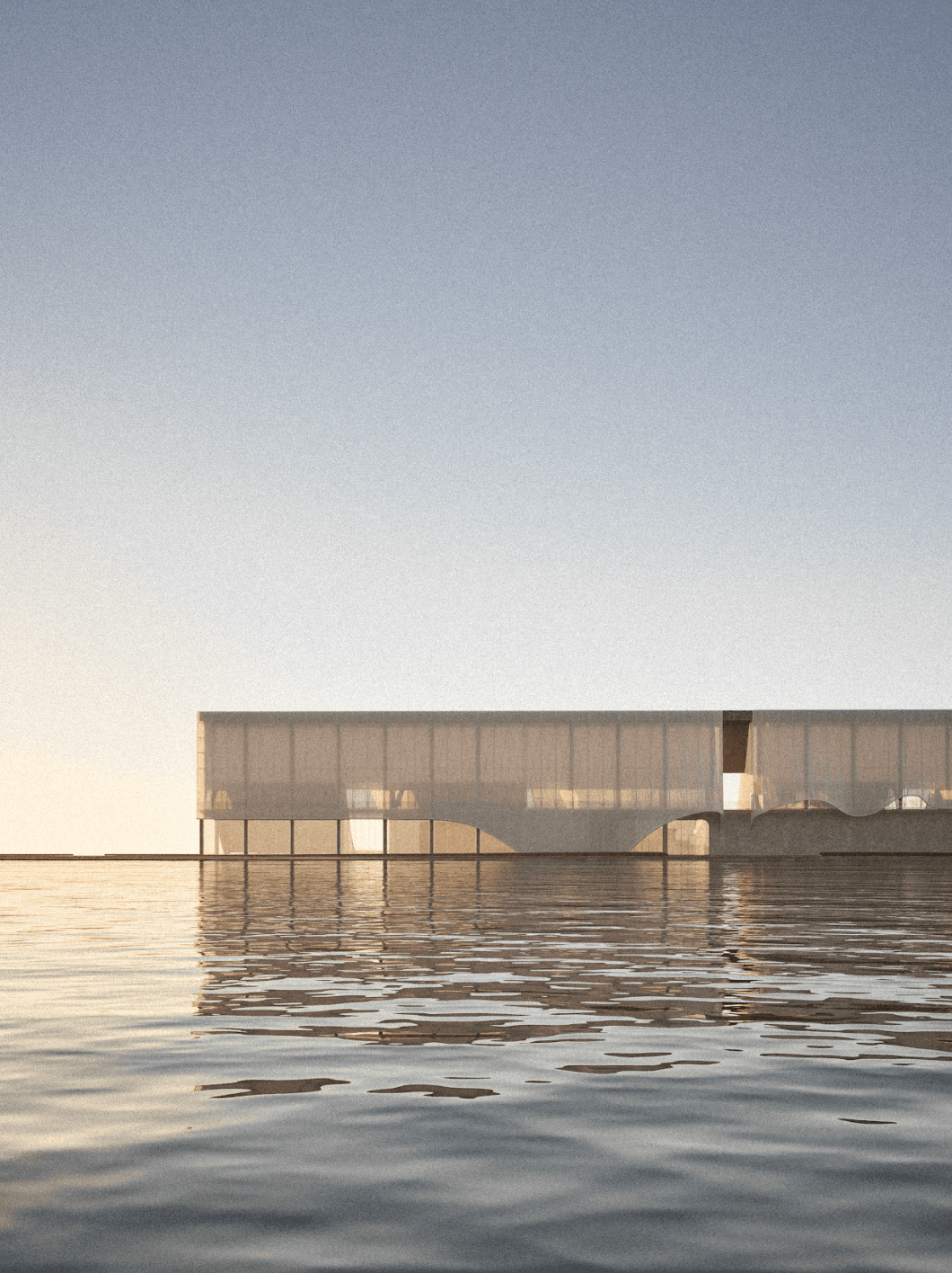 View across the water toward a glazed museum volume with the long concrete wall behind it