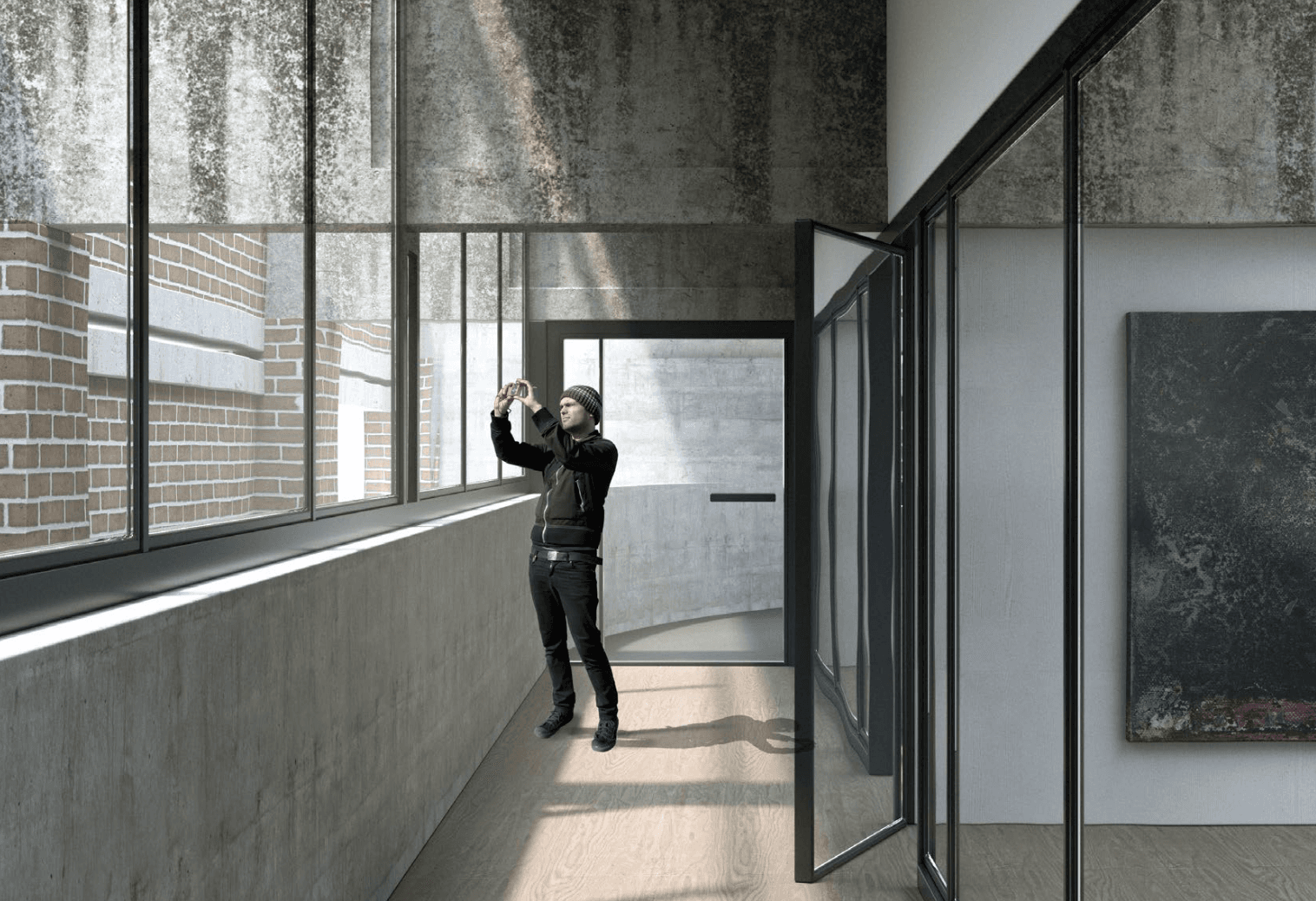 Glazed corridor with a visitor raising a camera beside a window overlooking planting